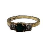 A VINTAGE 9CT GOLD, EMERALD AND DIAMOND RING The round cut emerald edged with diamonds. (emerald