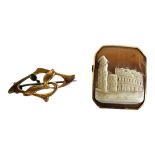 A 19TH CENTURY CONTINENTAL YELLOW METAL CAMEO BROOCH Carved with classical ruins of The Colosseum,