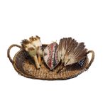 TWO NATIVE AMERICAN FEATHER AND LEATHER FANS The hand stitched tan leather handles set with exotic
