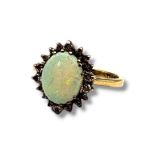 A VINTAGE 9CT GOLD, OPAL AND DIAMOND RING The oval cut opal edged with diamonds, (approx total