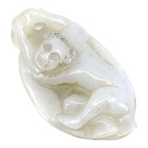 A CHINESE WHITE JADE ‘BOY ON LEAF’ CARVED PENDANT The pendant depicting a boy clinging onto the stem