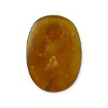 AN 18TH/19TH CENTURY CARVED CARNELIAN INTAGLIO DEPICTING A FAUN/SATYR Having large protruding chin