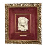 A 19TH CENTURY CARVED PORTRAIT BUST OF A BABY CRYING IN SHAWL, TITLED ‘THE PIN THAT PRICKS’ FROM THE