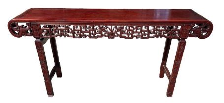 A LARGE CHINESE HARDWOOD ALTAR TABLE The plank top above a carved and priced frieze and scrolling