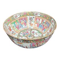 A LARGE EARLY 19TH CENTURY CHINESE CANTON FAMILLE ROSE BOWL Circular form having multiples panels