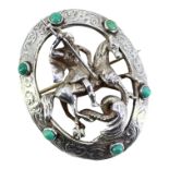 HAROLD ARTHUR LAZARUS, A LARGE CELTIC STYLE SILVER AND TURQUOISE BROOCH SHOWING ST. GEORGE SLAYING