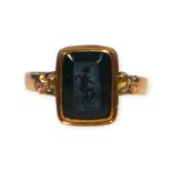 A 19TH CENTURY FRENCH 14CT GOLD CARVED BLACK CHALCEDONY NICOLO INTAGLIO DEPICTING EROS (CUPID)