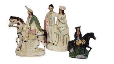 A VICTORIAN STAFFORDSHIRE FIGURAL GROUP MODELLED AS A MARRIED COUPLE Highlighted with gilt, a