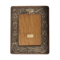 AN ART NOUVEAU SILVER PHOTOGRAPH FRAME Embossed organic form on oak easel back frame, hallmarked