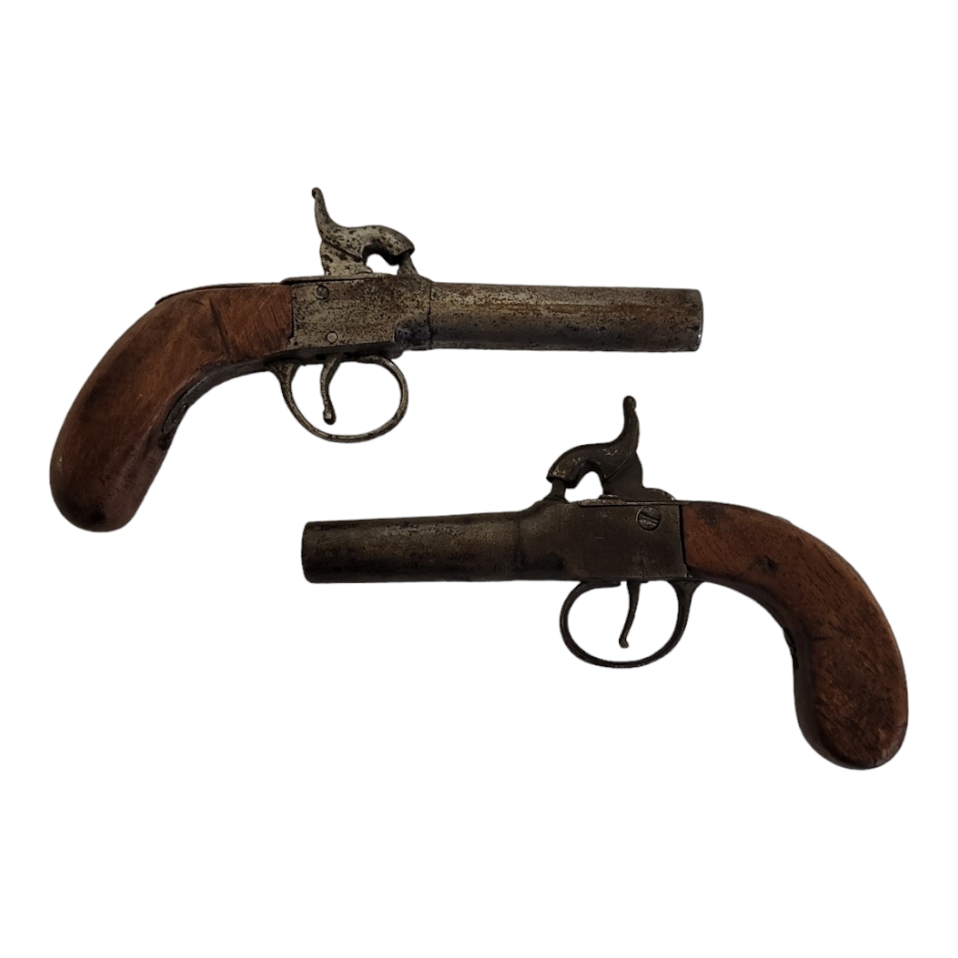 TWO LATE 18TH/EARLY 19TH CENTURY PERCUSSION CAP PISTOLS Having steel barrels and carved wooden