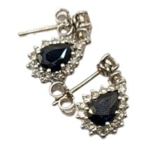 A PAIR OF 18CT WHITE GOLD, SAPPHIRE AND DIAMOND EARRINGS Set with a pear cut sapphire edged with