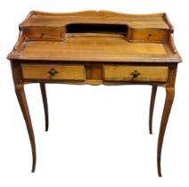 AN AMERICAN PINE WRITING TABLE With an arrangement of four drawers, raised on square swept