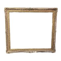 AN EARLY 20TH CENTURY ITALIAN STYLE PARCEL GILT PICTURE FRAME Surmounted by stylized scrolling