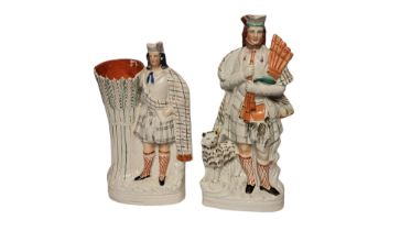 A VICTORIAN STAFFORDSHIRE FLATBACK FIGURE MODELLED AS A SCOTTISH PIPE PLAYER AND DOG COMPANION A