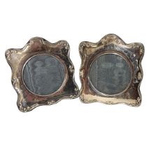 A PAIR OF 20TH CENTURY BRITANNIA SILVER PHOTOGRAPH FRAMES Having scrolled frame with ebonised wooden