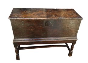 AN 18TH CENTURY ELM AND OAK COFFER ON STAND The single plank top single plank body, internal