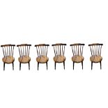 A SET SIX 20TH CENTURY SWEDISH BEECH WOOD SPINDLE BACK CHAIRS Having a shaped back rail,turned stick