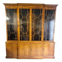 A 19TH CENTURY STYLE YEW BREAKFRONT WING BOOKCASE With four astragal glazed doors above