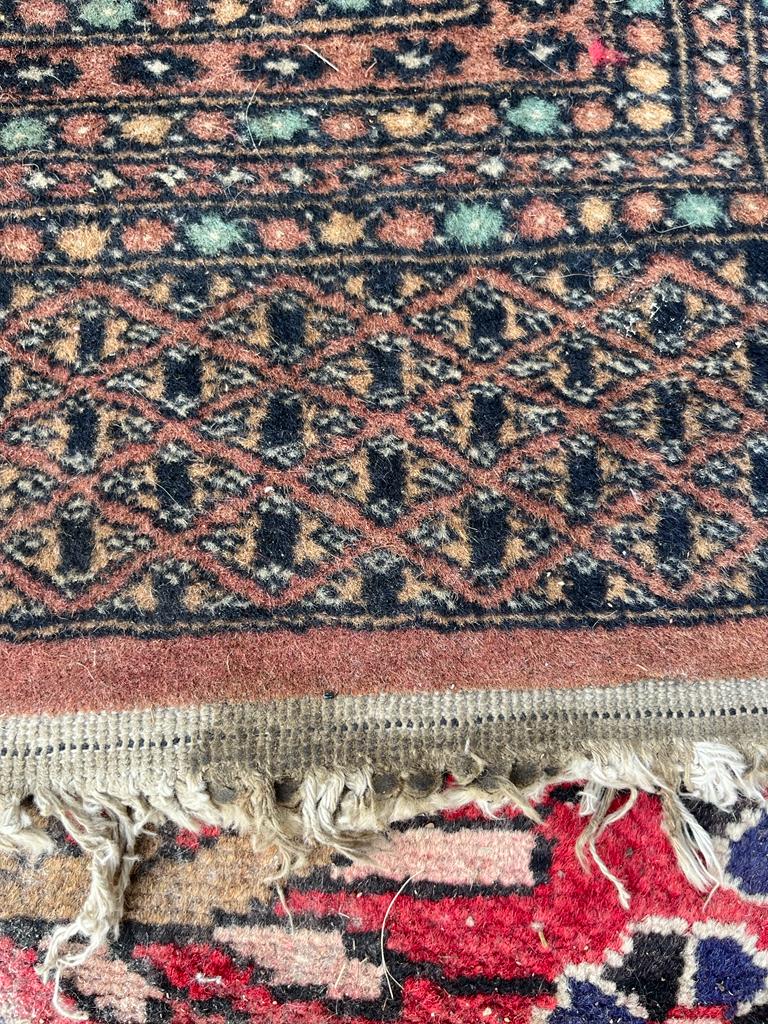 A BOKHARA WOOLLEN RUNNER RUG Having a row of guls to central burnt orange field with seven running - Image 2 of 2