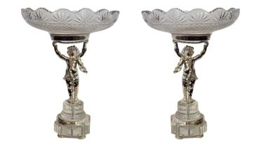 A PAIR OF SILVER PLATE AND CUT LEAD CRYSTAL GLASS FIGURAL TAZZAS Having hobnail cuts to glass,