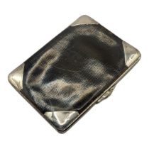 AN EDWARDIAN SILVER AND LEATHER GENTLEMAN'S WALLET Four silver corners hallmarked London, 1904, with
