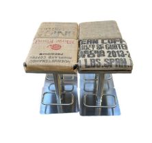 A SET OF FOUR STAINLESS STEEL HYDRAULIC BAR STOOLS In sign written hessian fabric upholstery, on