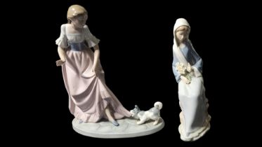 LLADRO, A PORCELAIN FIGURE OF A SEATED MADONNA WITH HOLY LILIES Painted in monochrome glazes,