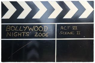 A LARGE HAND PAINTED WOODEN THEATRE PROP CLAPPERBOARD ‘Bollywood Nights 2006’, written in gold font,
