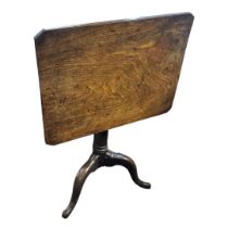 AN 18TH CENTURY SOLID MAHOGANY TILT TOP SUPPER TABLE The rectangular top on turned cannon barrel