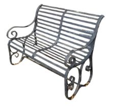 A VICTORIAN WROUGHT IRON TWO SEAT GARDEN BENCH With strap work seat and back on scrolling arms and