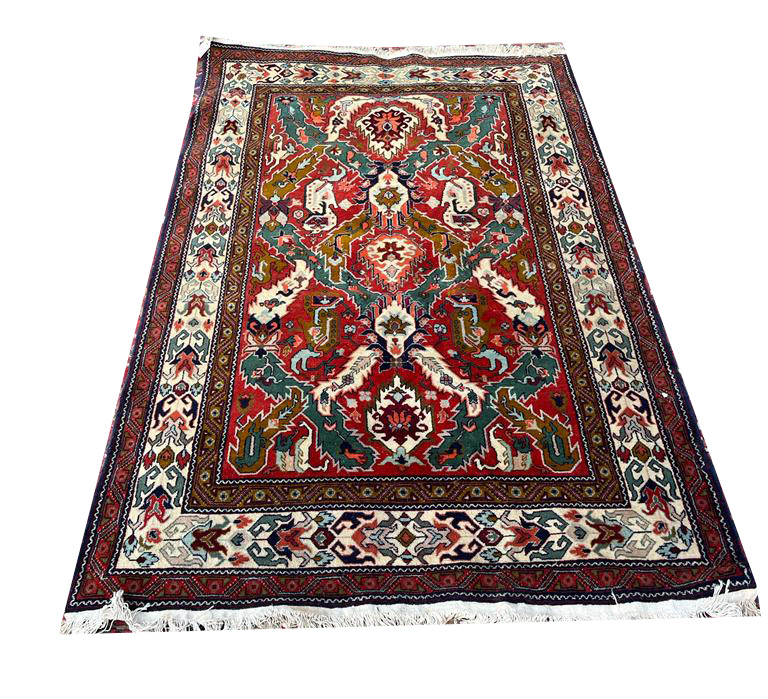 A PERSIAN WOOLLEN RUG Having three lozenge motifs on red and green ground with three running