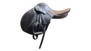 EQUESTRIAN INTEREST, AN EARLY 20TH CENTURY BROWN LEATHER BOUNDED HORSE SADDLE With steel rowels. (