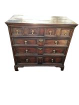 A 17TH CENTURY AND LATER OAK CHEST Of two short above three long drawers with brass teardrop handles