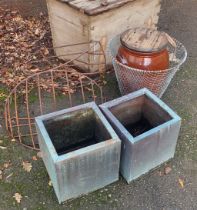 TWO IRON ANIMAL FEEDERS Along with a large stoneware jar, wire basket, pair of galvanized steel