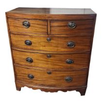 AN EARLY 19TH CENTURY MAHOGANY BOW FRONTED CHEST Of two short above three long drawers, with