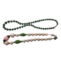 TWO EARLY 20TH CENTURY CHINESE JADE NECKLACES Having an arrangement of spherical pink jade beads