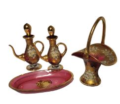 MURANO, A COLLECTION OF VINTAGE ITALIAN RUBY GLASSWARE Comprising a basket and a pair of olive oil