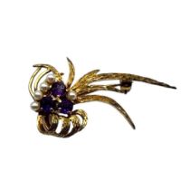 A VINTAGE 9CT GOLD, AMETHYST AND SEED PEARL BROOCH The cluster of three amethyst stones, edged