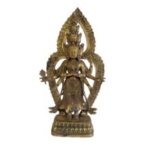 A GILT BRONZE FIGURE OF VISHNU Having multiple heads and arms and inlaid with coloured glass