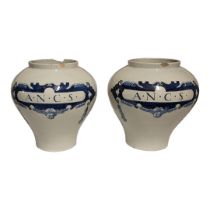 A LARGE PAIR OF EARLY 20TH CENTURY DUTCH DELFT OVOID POTTERY JARS With underglaze blue cartouche and