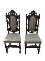 A PAIR OF VICTORIAN CARVED OAK CHILDS CHAIRS With shell cartouche, padded backs and upholstered