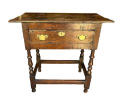 A 17TH CENTURY OAK SIDE TABLE The single drawer with brass fittings on square and turned legs, Circa