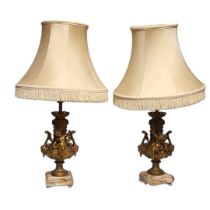 A PAIR OF EARLY 20TH CENTURY FRENCH GILDED SPELTER CHERUBS LAMP BASES Both having scrolling