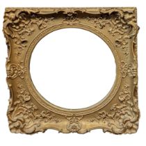 A 19TH CENTURY GILT FRAMED MIRROR With shell and floral cartouches surrounding a circular plate. (