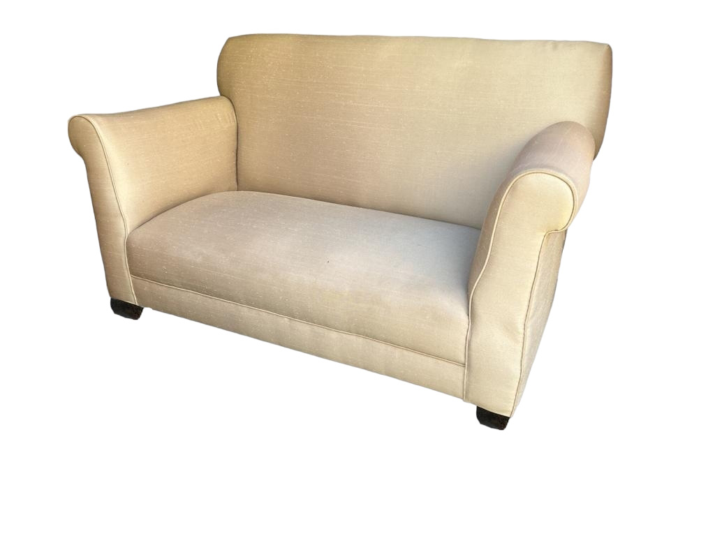 AN EDWARDIAN SINGLE DROP END TWO SEAT SETTEE In recent cream fabric upholstery, on squat tapering