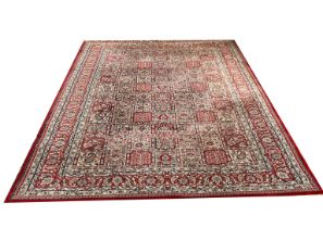 AN INDIAN WOOLLEN RUG OF CARPET PROPORTIONS Having multi square designs to central field on red