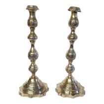 A PAIR OF 20TH CENTURY SILVER CANDLESTICKS Having engraved decoration and scrolled base. (approx
