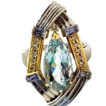 AN 18CT BICOLOUR GOLD, AQUAMARINE AND DIAMOND CLUSTER RING The central pear cut aquamarine flanked