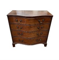 AN EARLY 19TH CENTURY MAHOGANY SERPENTINE CHEST Of four graduating drawers, fitted with brass swan