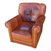 A TAN LEATHER UPHOLSTERED CLUB ARMCHAIR With two loose cushions. (w 87cm x d 85cm x h 95cm)